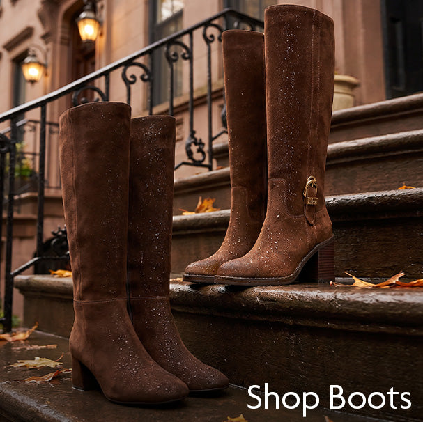 Four brown suede knee-high boots with subtle glitter and block heels arranged on outdoor stone steps in front of a building, with the text 'Shop Boots' in the bottom right corner.