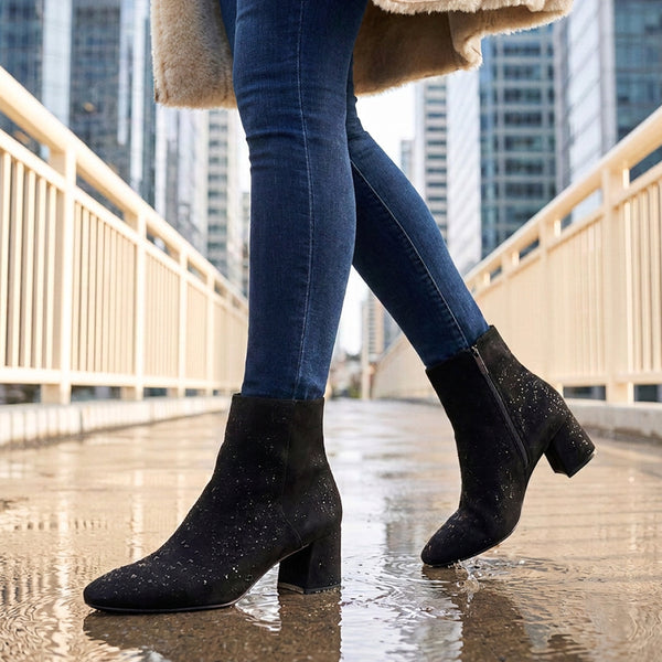 ALIDA Black suede waterproof ankle boots with block heels, worn with blue skinny jeans on a rainy city bridge walkway. - thumbnail image 2 of 64